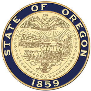 The official state seal of the state of Oregon. An eagle with spread wings adorns the top of the seal with 2 oxen pulling a carriage in the center.