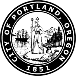 The official seal of the city of Portland Oregon which showcases a woman holding a trident standing at a shore. In the background is a ship floating in the water and a mountain peak.