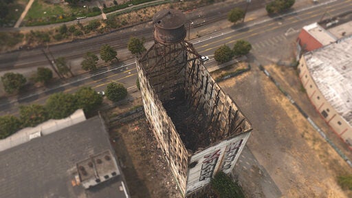 Aerial view of Centennial Mills Warehouse after massive fire. The roof is gone and the building is a hollow shell.