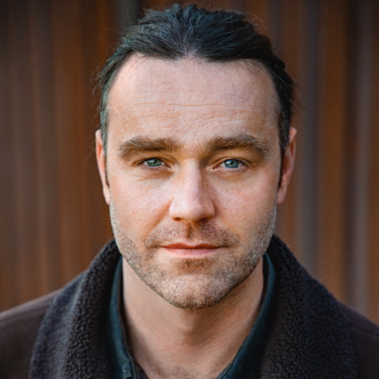 Head shot of man looking directly into the camera.